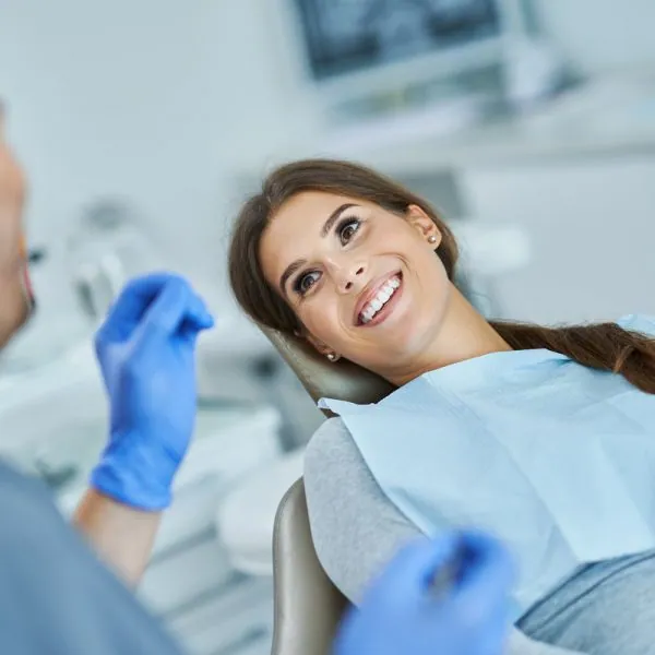 Male dentist and woman in dental clinic