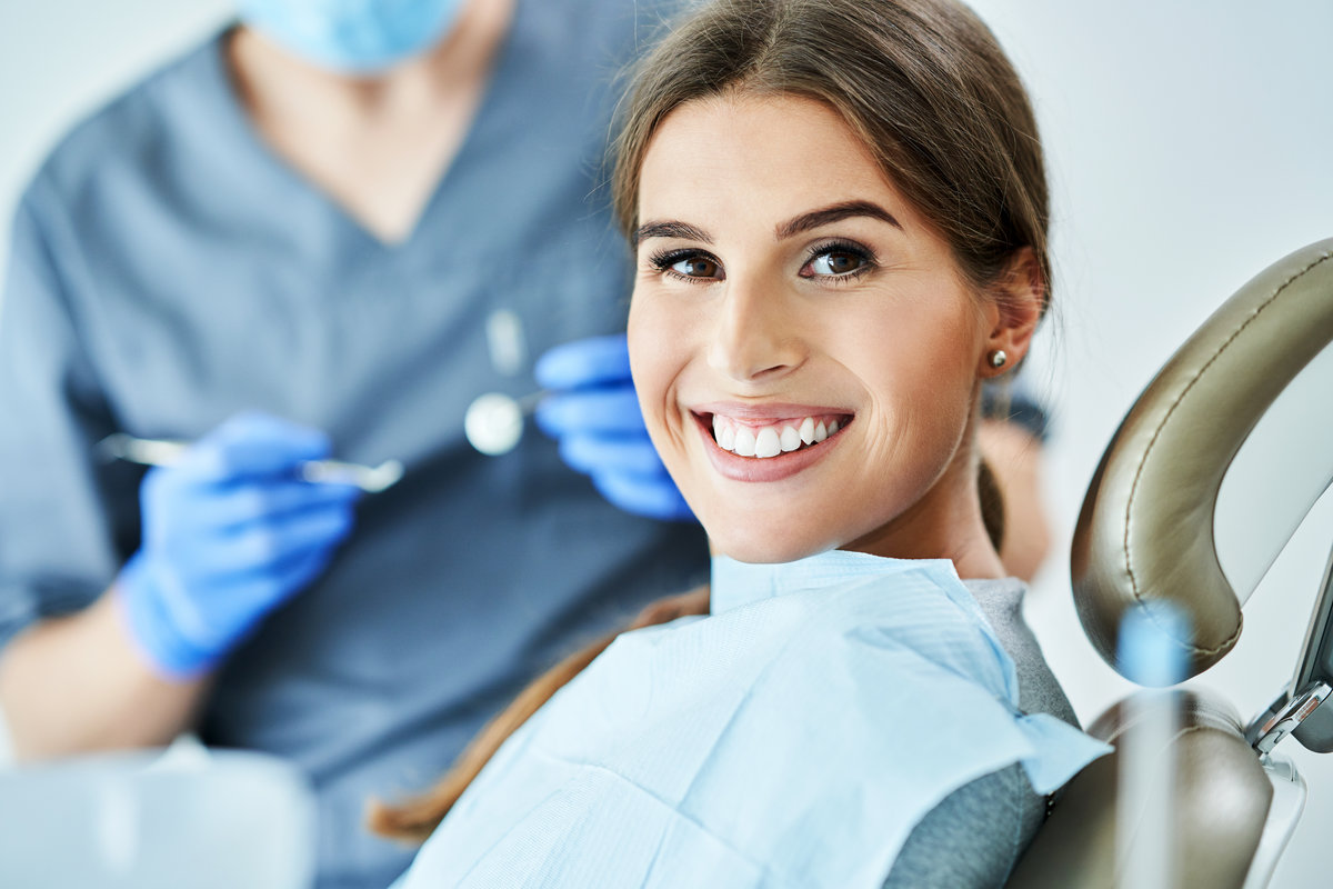 Male dentist and woman in dental clinic