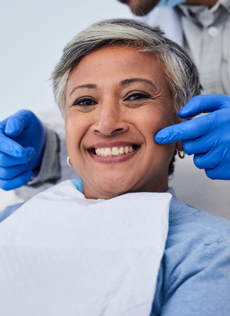 Happy senior woman, teeth and dentist for dental care, appointment or checkup at clinic. Portrait of elderly female person smile for tooth whitening, cleaning or oral, mouth and gum care at hospital